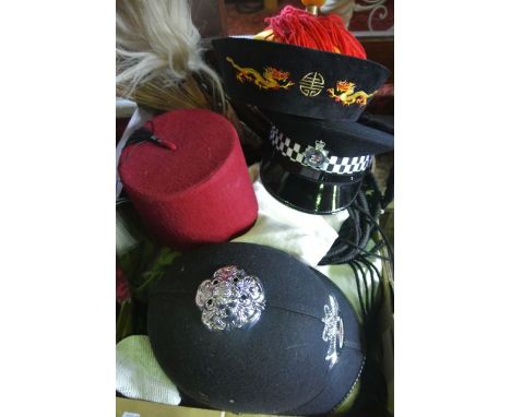 A collection of hats and caps of global origin to include Arabic headwear, hats with embroidered and other detail, a Policema