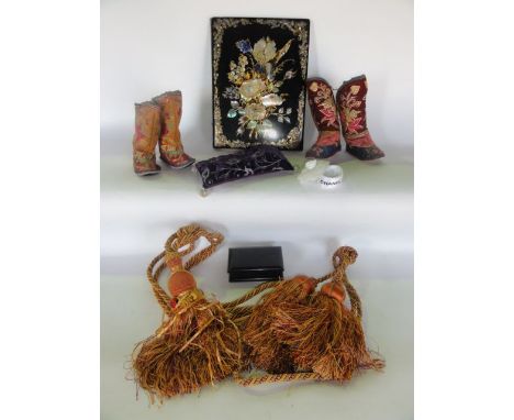 A Victorian black lacquered and mother-of-pearl inlaid desk blotter, two pairs of Chinese embroidered books, tassels, etc