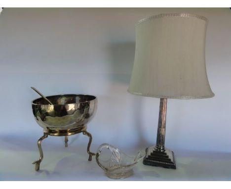 An unusual brass bowl of semi-spherical form seated upon a circular base with three sweeping supports, with an associated lad