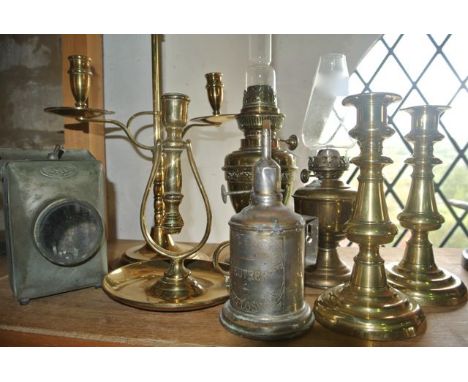 A selection of brass and other lighting to include a brass ship's candlestick on a pivoting stem, a Sunlight Junior lamp, a F