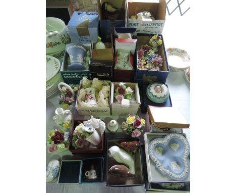 A quantity of decorative ceramics, including many boxed examples, including ceramic posies, Beswick model of a wren, Arden Co