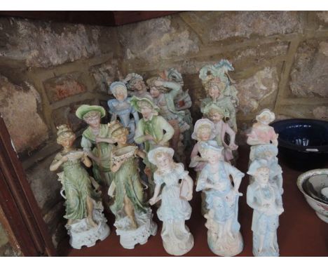A collection of seventeen late 19th century continental bisque figures of ladies and gentlemen in 19th century style and clas