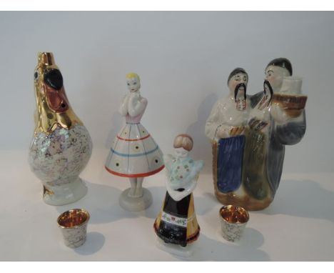 A collection of eastern European ceramic wares including a figure of a young girl, marked to base Ukrainian, a further simila