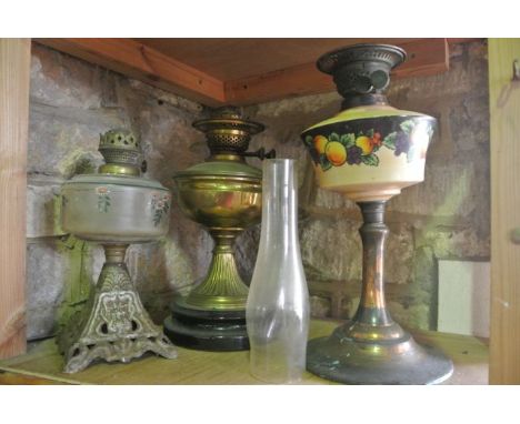 A brass oil lamp with vertical embossed detail, set upon a heavy ebonised base with Duplex burner, A further Victorian oil la