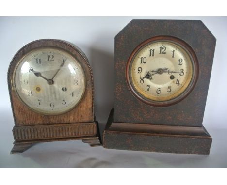 An Edwardian oak mantle clock with arched casework with beaded border and one other similar 