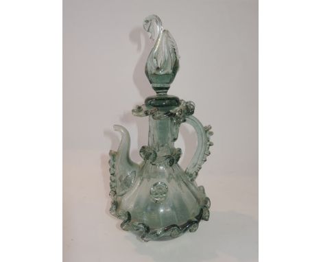A 19th century hand blown pale blue glass ewer in the Venetian manner with extensive scrolling applied borders set beneath an
