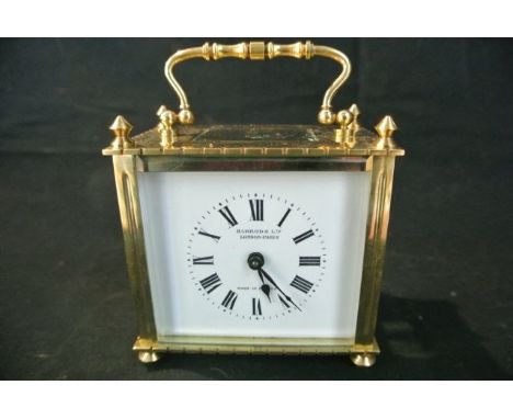 A French brass carriage clock, the case of square outline, with enamel dial and 8-day timepiece, with leather travelling case