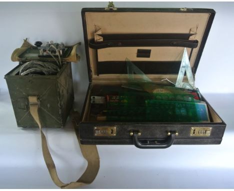 A Second World War signalling unit complete with lamp set within a camouflage green aluminium case together with a suitcase c