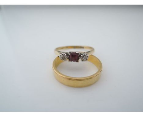 A ruby and diamond ring, centred with a square stepped-cut ruby, flanked to either side with a round brilliant-cut diamond, i