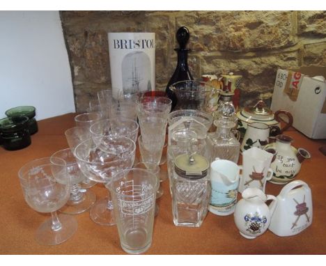 A collection of drinking clear drinking glasses to include examples with Greek key and other incised decoration, a Bristol co