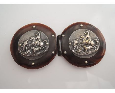 A Victorian style faux tortoise shell buckle, mounted with a silver-plated motif, embossed with a hunting scene 