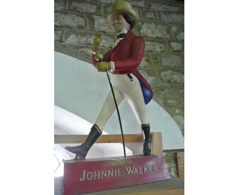 A vintage Johnnie Walker whisky shop display/advertising piece in the form of Johnnie in characteristic striding pose brandis