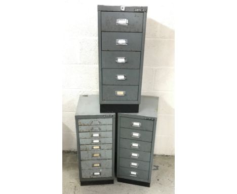 Three metal cabinets from a watchmakers workshop containing a selection of miscellaneous items to include straps, mainsprings