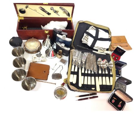 A boxed wine accessories including cork screw and wine stopper, a collapsible stainless steel cup in a stainless steel case (