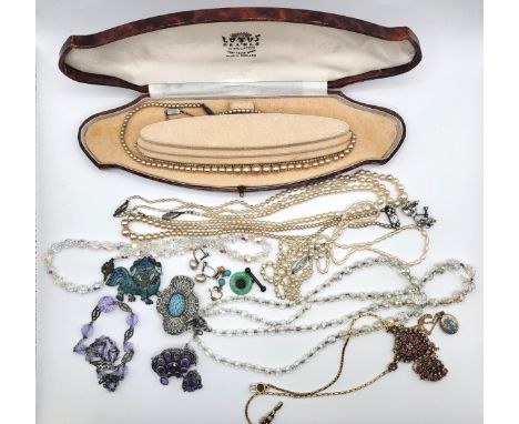 A selection of costume jewellery including faux pearls, freshwater pearls, a Chinese dragon fastener, paste screw back earrin