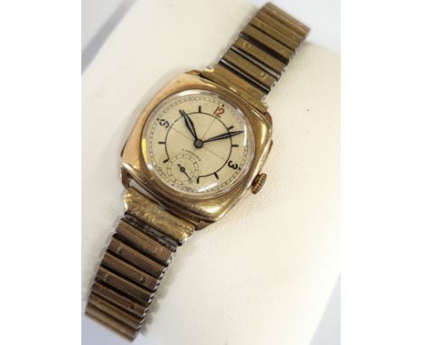 A 9ct gold 1930's Longines cushion style watch with latter fitted gold plated expandable bracelet.
