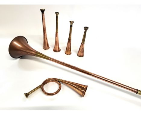 Five hunting horns, approx lengths 23cm, and a coach horn 120cm.