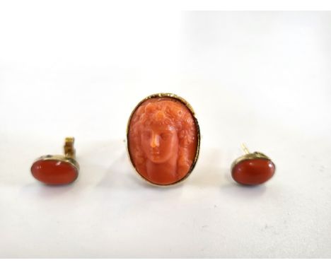A pair of coral earrings with 9ct yellow gold posts and backs and a coral cameo of a maiden's face ring set yellow gold (unma