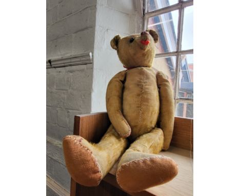 A 1920's Teddy Bear with original wooden eyes.48cm.