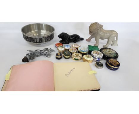 A collection of trinket boxes, two carved lions, a car's radiator mascot, a pewter bowl, and a collection of autographs inclu