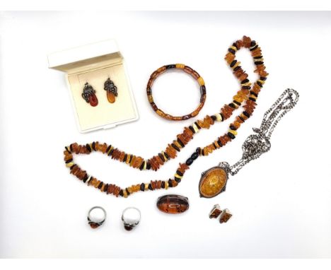 A collection of silver and amber jewellery including earrings, bracelet, necklaces, rings (size O 4.7gms, and size K 3.5gms),