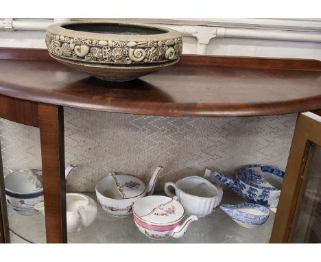 Seven antique feeding cups and a ceramic bowl.