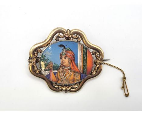 A 9ct yellow gold (unmarked but tested) boxed brooch of an Indian royal hand painted portrait in an ornate gold surround  a g