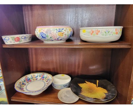 Three Poole bowls and four dishes 12.5cm to 27cm diameter. (7)