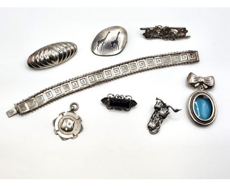 A bag of mixed silver items including a bracelet with a geometric and beaded edge design, an oval locket with bow, a giraffe 