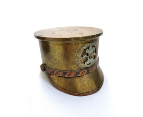 A collection of brass and metalware including two brass tables, two trench art souvenirs in the shape of a soldier's hat (wit