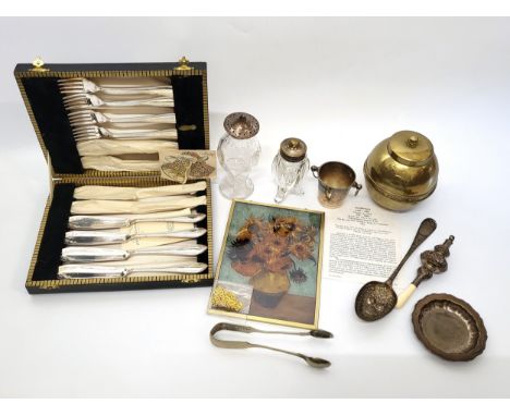 A collection of silver including spoons and a pair of tongs, cut glass bottle with a silver top, a cut glass bottle with a si