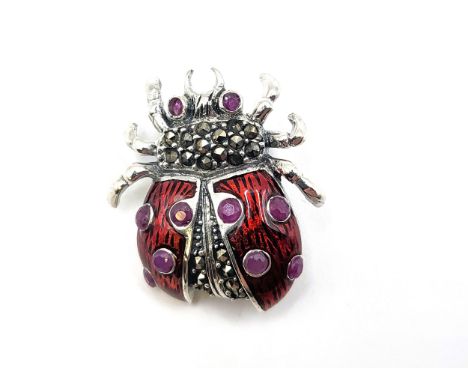 A silver (925) and enamel ladybird brooch set with marcasites and rubies. 3cm x 2.5cm 6.3gms.