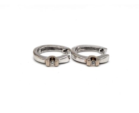 A boxed 18ct white gold diamond hoop earrings each consisiting of one brilliant cut round diamond approx. TCW 0.18ct mount in