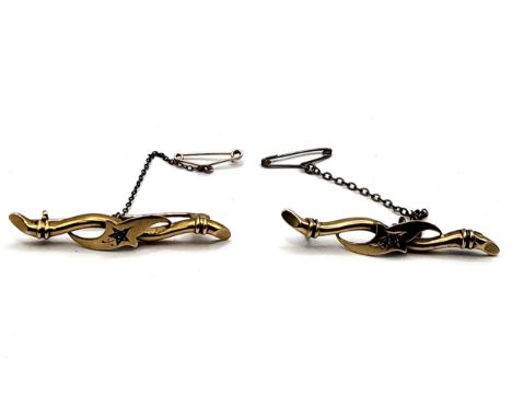 Two 15ct stamped yellow gold tie pins with a central diamond chip and safety chain. One hallmarked Birmingham, the other Ches