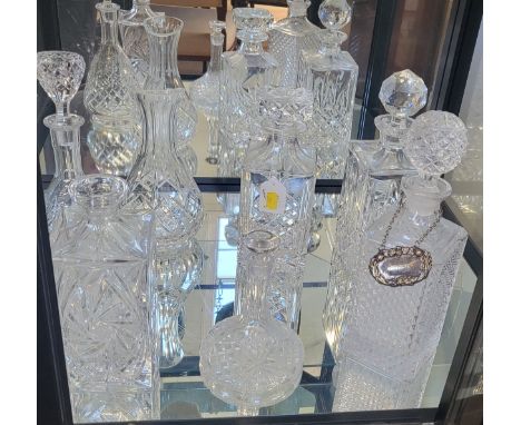 Six cut glass decanters with stoppers, one with plated metal Whisky tag, and a pear-shaped carafe. (7)
