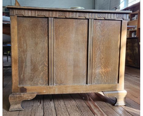 A wooden ottoman with a hinged lid, a decorative frieze at top, and on bracket feet. 77cm x 93cm x 49cm.