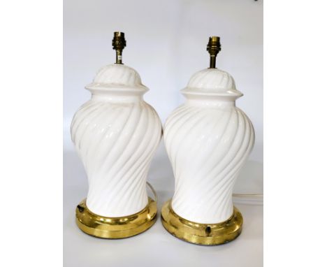 A pair of white ceramic swirl pattern table lamps. (2)