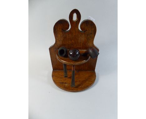 An Oak Pipe Rack Containing Three Vintage Pipes, 26cm High 