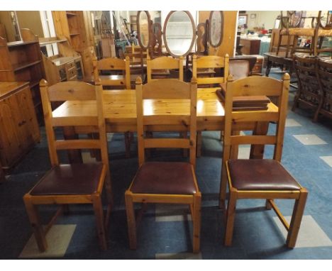 A Rectangular Pine Dining Table and Six Ladder Back Chairs