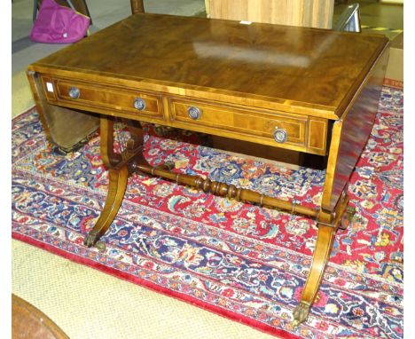 A reproduction yew wood sofa table on lyre end support, 103cm open.