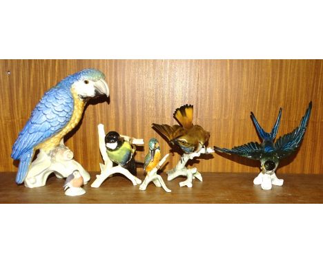 A Goebel porcelain model of a parrot, with blue, green and orange plumage, impressed CV79 and 1967 to base, 21cm high, a Goeb