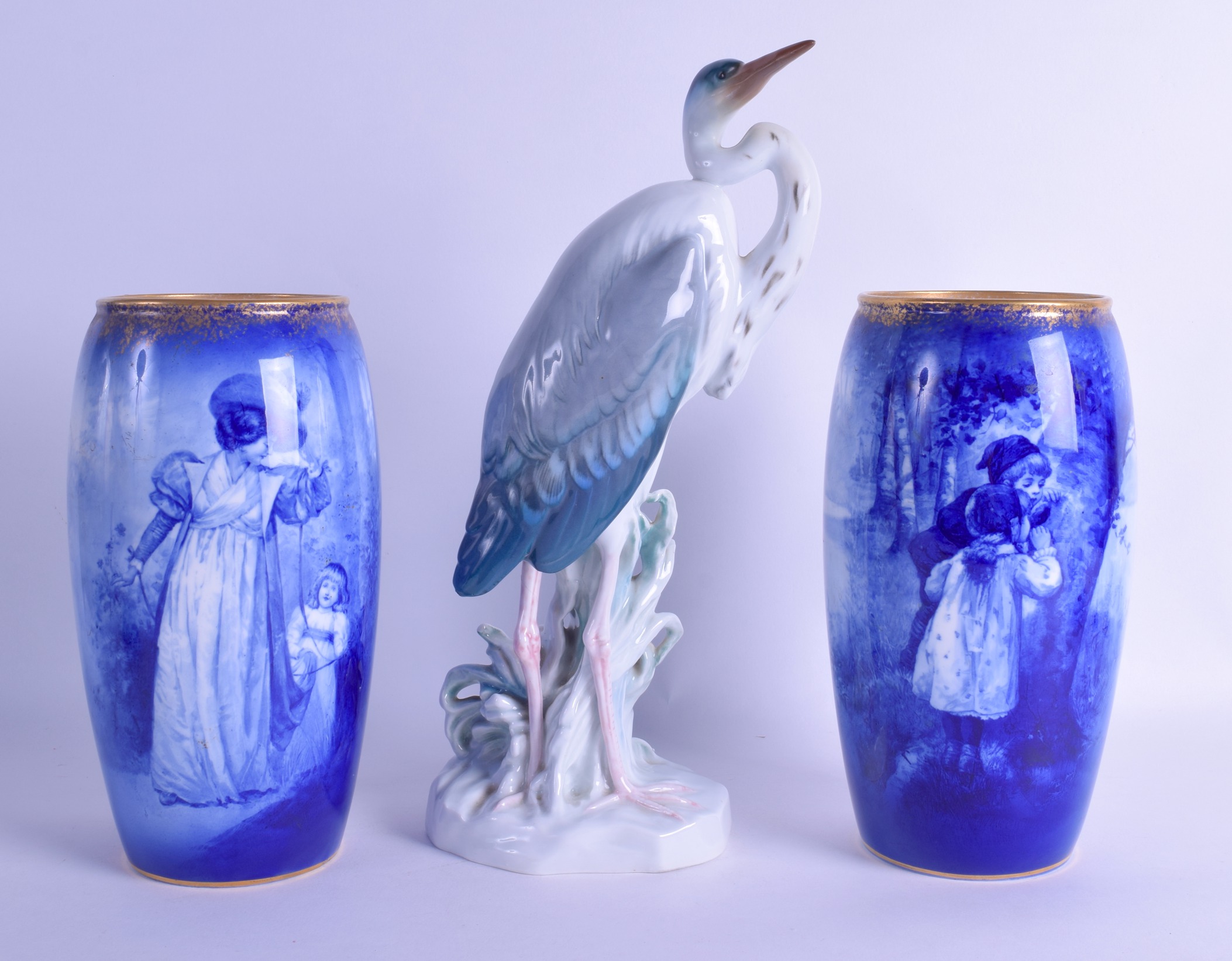 A PAIR OF ROYAL DOULTON BLUE AND WHITE VASES printed with figures
