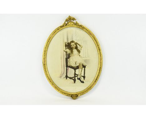 A Framed Sepia Tone And Hand Tinted Portrait Of A Young Girl Housed in oval gilt frame , depicts a young girl in fashionable 