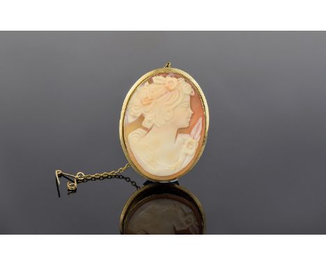 A Top Quality Oval Shaped Shell Cameo Brooch With Ornate 9ct Gold Mount With Attached 9ct Gold Safety Chain Depicts a portrai