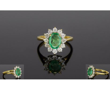 18ct Gold Emerald & Diamond Cluster Ring. The Oval Emerald Surrounded by 13 Diamonds. The Emerald of Good Colour 1cts. The Di