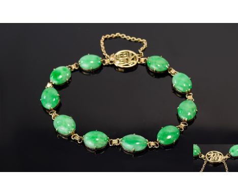 Jade Tennis Bracelet, oval cabochons of mottled green jade set in 14ct gold, each cabochon having a full backplate of the gol