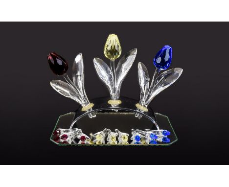 Three Swarovski Display Tulips 1. Yellow Tulip code number 657355  2. Tulip with a smooth Clear crystal stem and leaves, and 