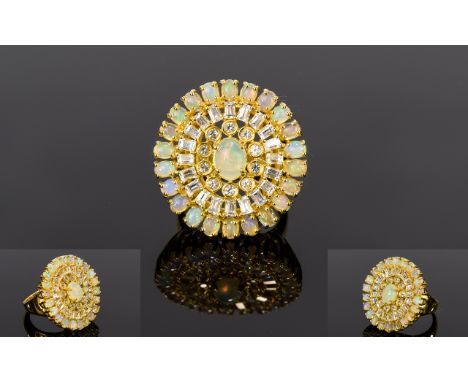 Ethiopian Opal and White Topaz Halo Ring, radiating out from a 1ct oval cut opal to the centre is an oval of bezel set, round