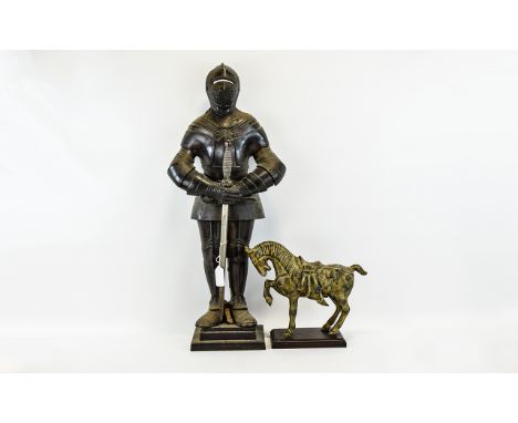 Cast Metal Figures Two in total, the first in the form of a medieval knight in armour holding a sword. The second, a small ca