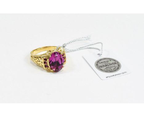 Swarovski Fuchsia Crystal Ring, an oval cut fuchsia pink crystal set between two rows of three tiny, similar crystals, in a g